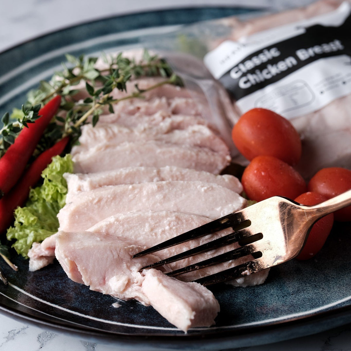 Sliced Heaven Eat chicken breast on a plate beside its pack